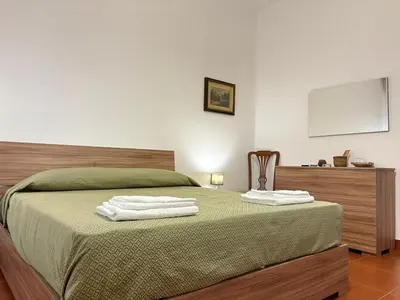a bedroom with a bed with two towels on it at Villa Cetti a Mondello in Palermo