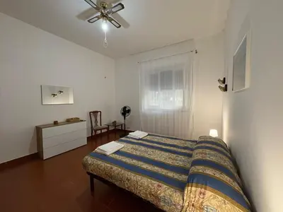 a bedroom with a bed and a ceiling fan at Villa Cetti a Mondello in Palermo