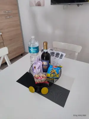 a basket of food and a bottle of water on a table at Le casette di Elia e Alice in Palermo