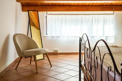 a chair sitting in a room with a window at Villa Luna Scopello in Castellammare del Golfo