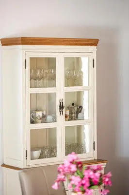 a white cabinet with cups and dishes in it at Villa Luna Scopello in Castellammare del Golfo