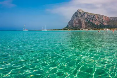 a large body of water with a mountain in the background at Casa vacanze CaMi in Alcamo