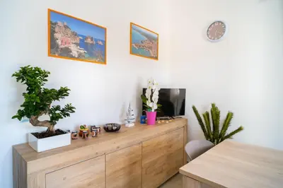 a room with a wooden dresser with a tv on it at Casa vacanze CaMi in Alcamo