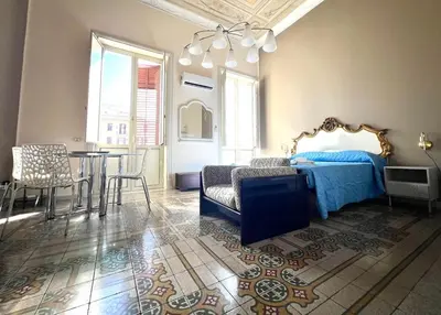a bedroom with a bed and a table and chairs at House Wonderfull Palermo in Palermo