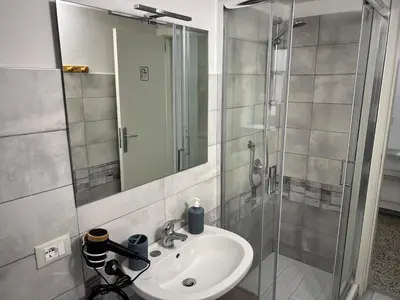 a bathroom with a sink and a shower at House Wonderfull Palermo in Palermo