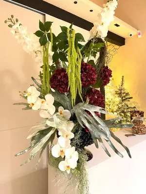 a vase filled with flowers on top of a table at Bìfara Rooms in Palermo