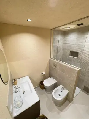 a bathroom with a sink and a toilet and a shower at Bìfara Rooms in Palermo