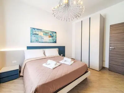a bedroom with a large bed with two towels on it at Apartment MareLuna by Interhome in Balestrate