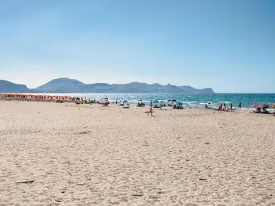 a group of people walking on a beach at Apartment MareLuce by Interhome in Balestrate