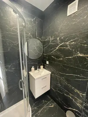 a black bathroom with a sink and a shower at Da Andrea in Carini