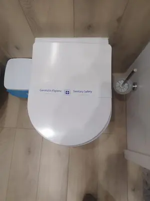 a white toilet with a sign on the side of it at Da Andrea in Carini