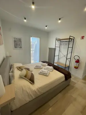 a bedroom with a bed with towels on it at Da Andrea in Carini