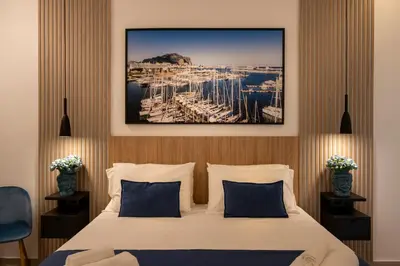a hotel room with a bed and a painting on the wall at Al Capo Suite Home in Palermo