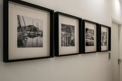 a group of framed photographs on a wall at Al Capo Suite Home in Palermo