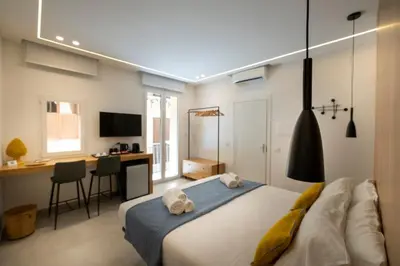 a bedroom with a bed and a desk with a computer at Al Capo Suite Home in Palermo