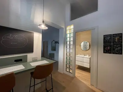 a bathroom with a counter with a sink and a desk at Appartamento la Noce in Palermo