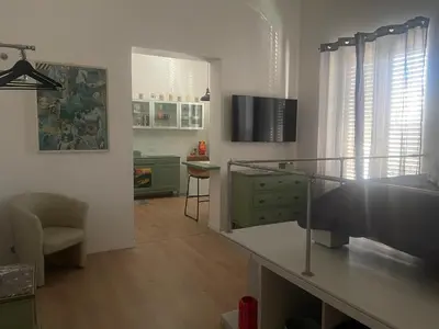 a living room with a desk and a chair in it at Appartamento la Noce in Palermo