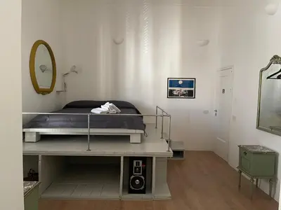 a bedroom with a bed and a mirror in a room at Appartamento la Noce in Palermo