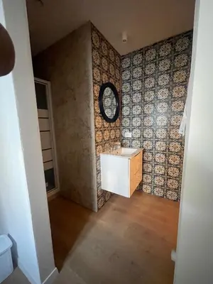 a bathroom with a sink and a clock on the wall at Appartamento la Noce in Palermo