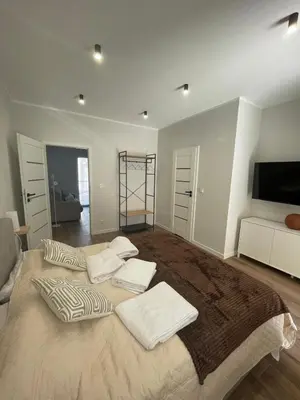 a bedroom with a large bed with three pillows on it at Gold Rooms in Carini