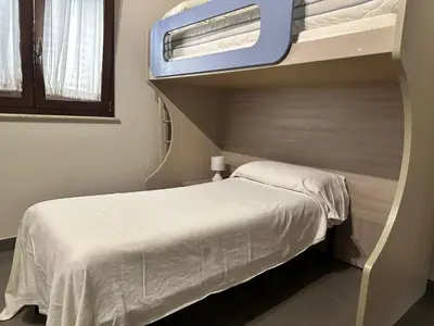 a bedroom with a bunk bed with a window at Matteotti 17 Easy in Cinisi