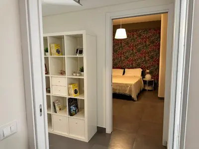 a bedroom with a bed and a book shelf at Matteotti 17 Easy in Cinisi