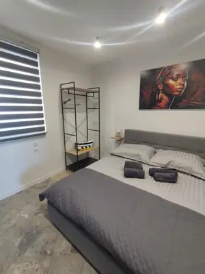 a bedroom with a large bed with a painting on the wall at Da Pietro in Carini