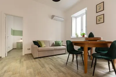 a living room with a couch and a table at Aromarìa Palace in Palermo