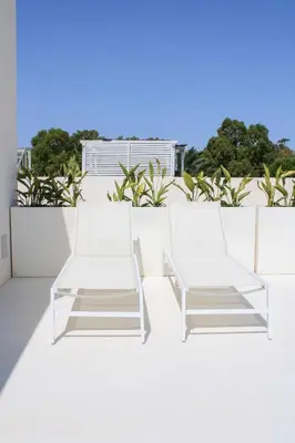 two white chairs sitting on top of a roof at Villa Ippolita - Studio with Esclusive Terrace in San Vito lo Capo