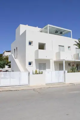 a white house with a fence in front of it at Villa Ippolita - Studio with Esclusive Terrace in San Vito lo Capo