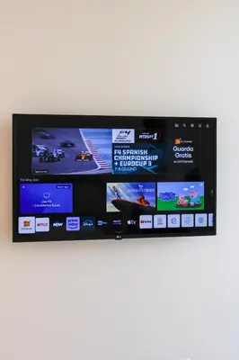 a television with several screens on a wall at Villa Ippolita - Apartment with Exclusive Garden in San Vito lo Capo