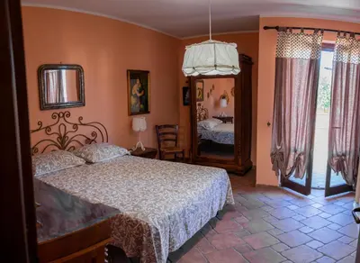a bedroom with a bed and a mirror at Casa Leandra in Casteldaccia
