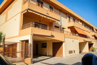 a building with balconies on the side of it at Casa Leandra in Casteldaccia