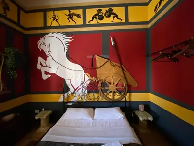 a room with a bed and a painting of a horse on the wall at Hollywood Inn Palermo in Palermo