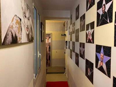 a hallway with a wall of pictures on the wall at Hollywood Inn Palermo in Palermo