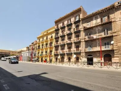 a large building on the side of a street at Hollywood Inn Palermo in Palermo