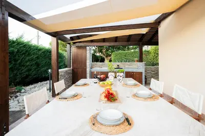a dining room with a white table and chairs at Villa Lipari in Castellammare del Golfo