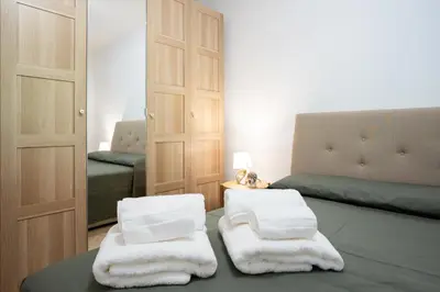 a room with two beds and two white towels at Villa Lipari in Castellammare del Golfo