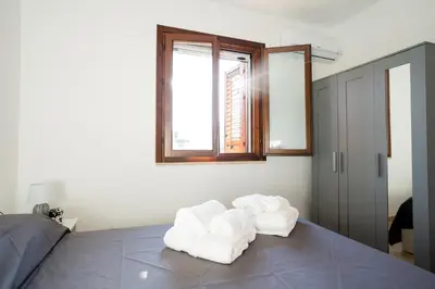 a bedroom with two towels sitting on a bed at Villa Lipari in Castellammare del Golfo