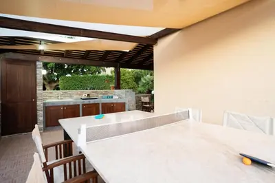 a kitchen with a large white table and chairs at Villa Lipari in Castellammare del Golfo