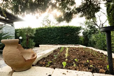 a garden with a vase sitting next to a yard at Villa Lipari in Castellammare del Golfo