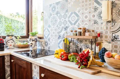 a kitchen counter with fruits and vegetables on a cutting board at Villa Lipari in Castellammare del Golfo