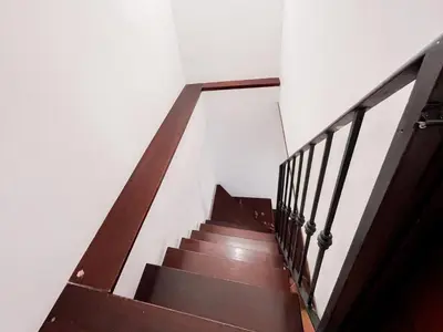 a staircase in a building with a wooden stair case at Kemonia home in Palermo