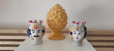 three vases sitting on a table next to a gold vase at Enjoy Palermo in Palermo
