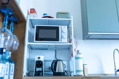 a microwave on a shelf in a kitchen at Casa Erasmo in Palermo