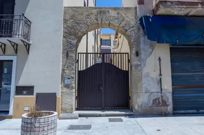 an entrance to a building with a black gate at Casa Erasmo in Palermo