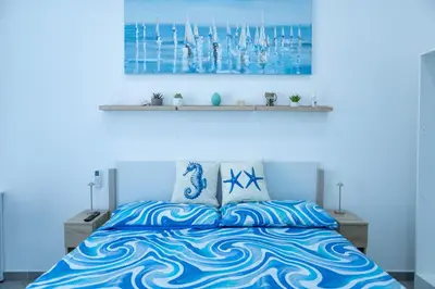 a blue bedroom with a bed with a blue bedspread at Casa Erasmo in Palermo