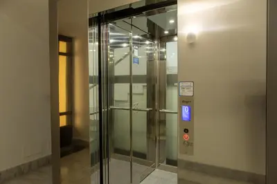 an elevator in a building with a glass door at Casa Erasmo in Palermo
