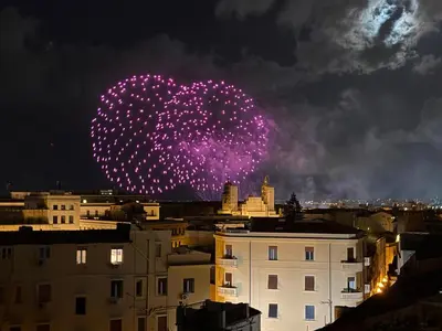 a firework heart in the sky over a city at Settimo Cielo al Massimo Guest House in Palermo