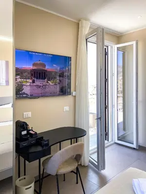 a room with a table and a view of a building at Settimo Cielo al Massimo Guest House in Palermo